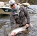 Woman with winter steelhead caught on a fly fishing trip with Raincoast Guides.
