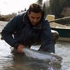 Fly fisherman with winter steelhead on Olympic Peninsula river