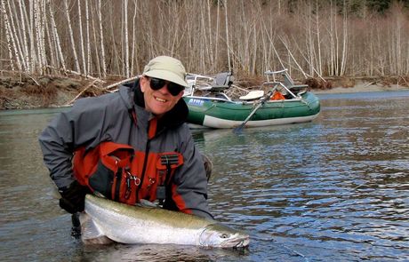 Fly fisherman with winter steelhead on Olympic Peninsula river