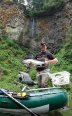 Beautiful northwest scenery with fisherman and steelhead